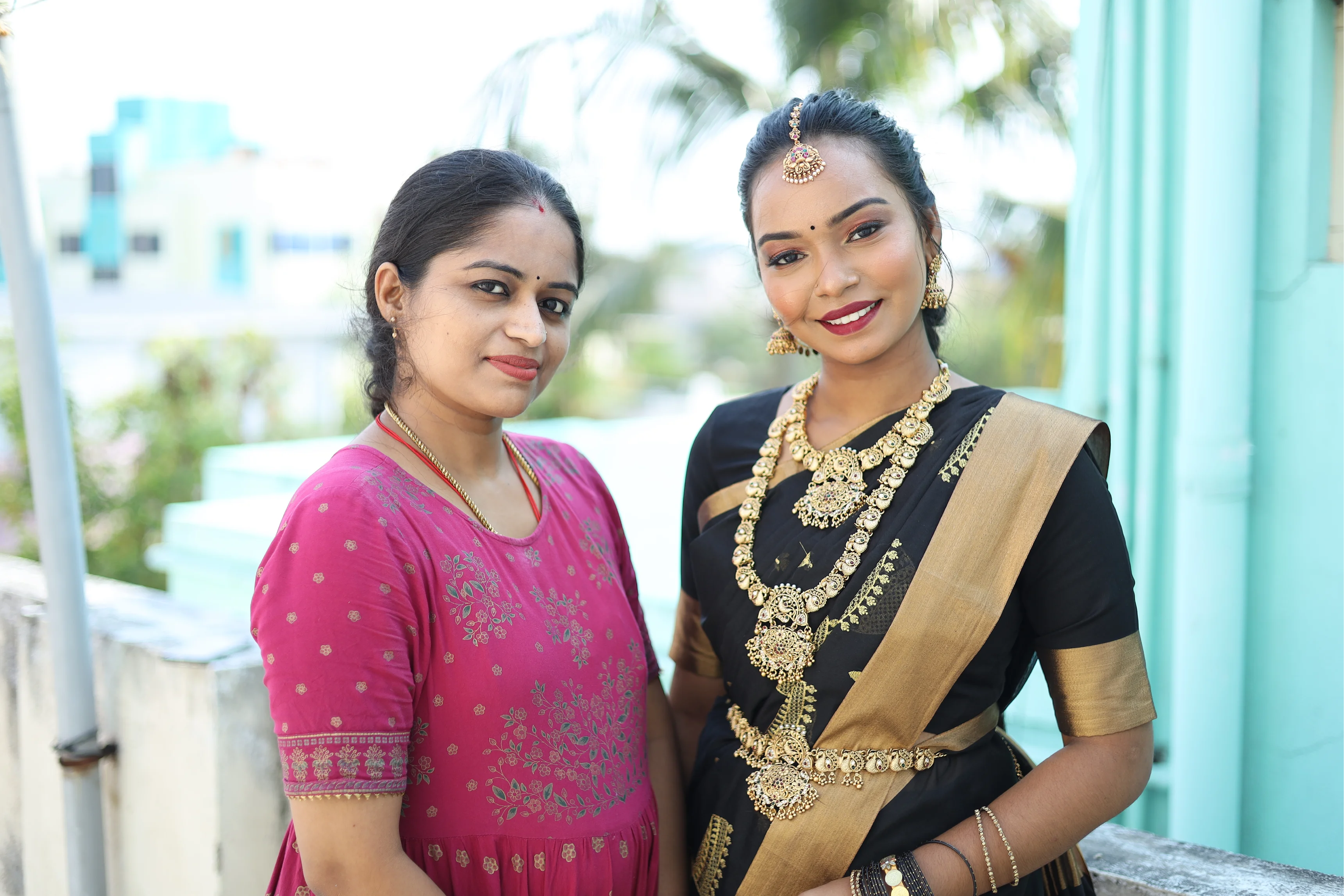 Bride with makeup artist in an outdoor portrait