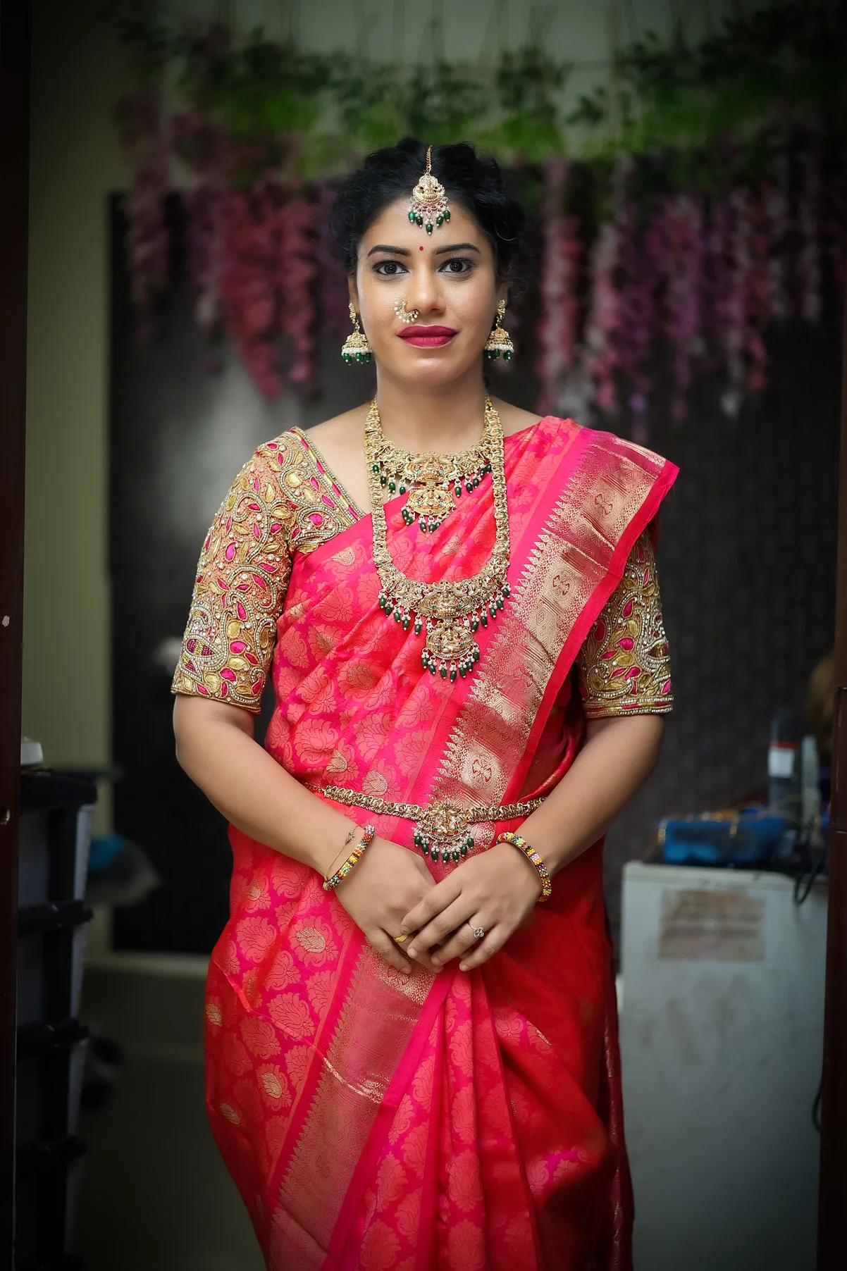 Bride posing with flowing red dupatta outdoors